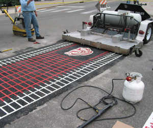 Asphalt Reheat Systems’ Manta Ray was used to install thermoplastic markings and a Badger logo at the University of Wisconsin-Madison.
