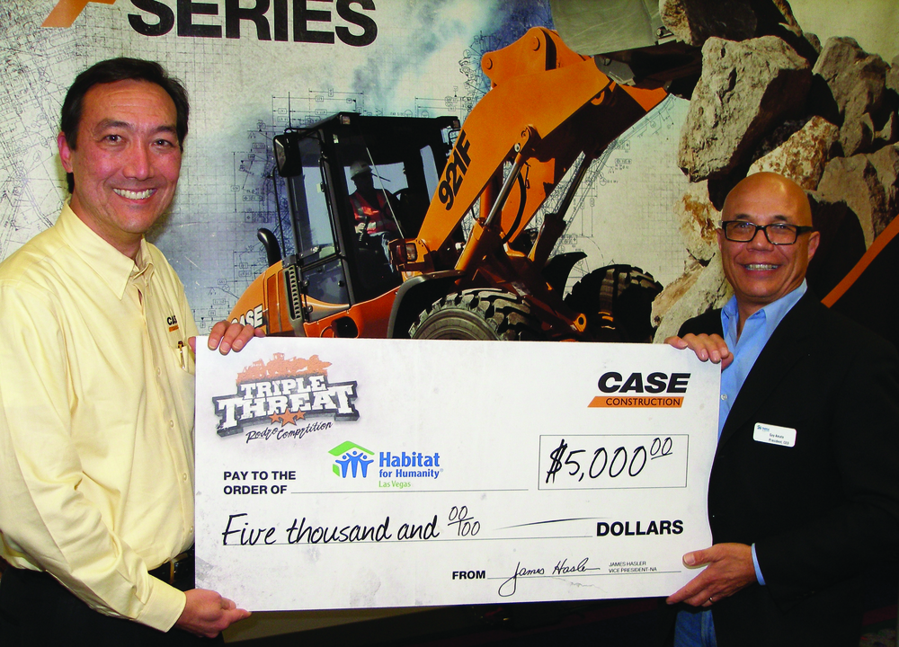 Ion Warner, Case director of North American marketing (left), delivers a check for $5,000 to Guy Amato, president and CEO at Habitat for Humanity Las Vegas. The check takes Case's aggregate donations to Habitat over $200,000, and Warner says the Triple Threat Rodeo should raise the total to more than $350,000.