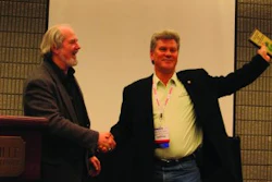 Ray Confer (right), president of C&J Parking Lot Sweeping, Warren, MI, accepts the 2011 WorldSweeper.com Award of Excellence in Power Sweeping from Ranger Kidwell-Ross, editor of WorldSweeper.com.