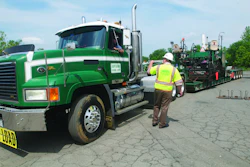 Superior Paving fleet manager Mike Blevin talks with a Superior Paving driver, who was hauling a low-boy trailer at the company's asphalt plant in Centreville, VA.