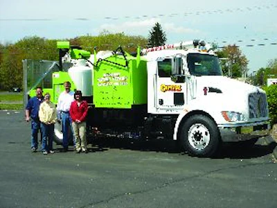 Dave Fisher, Hannah Smith, Tom Kuhns, and Lesa Kuhns (from left) with Capitol Sweeping Services' new infrared repair machine, the contractor's next step in bringing services in-house to help stabilize cash flow, keep employees busy, and become even more essential to its customers.