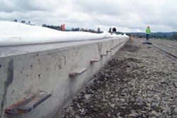 Steel plate dowels carry loads across a construction joint, maintain vertical alignment between adjacent slabs and allow concrete shrinkage both perpendicular and parallel to the joint.