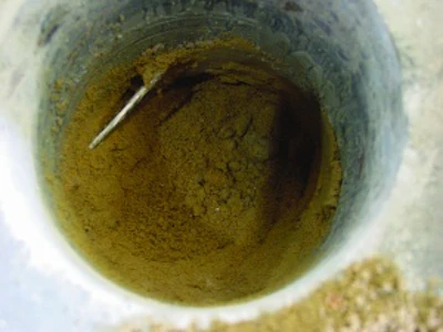 Reinforcement partially buried in the subbase does not provide crack width control. Without supporting chairs or pre-cast concrete blocks, reinforcement typically ends up in the bottom of the slab or buried in the subbase.