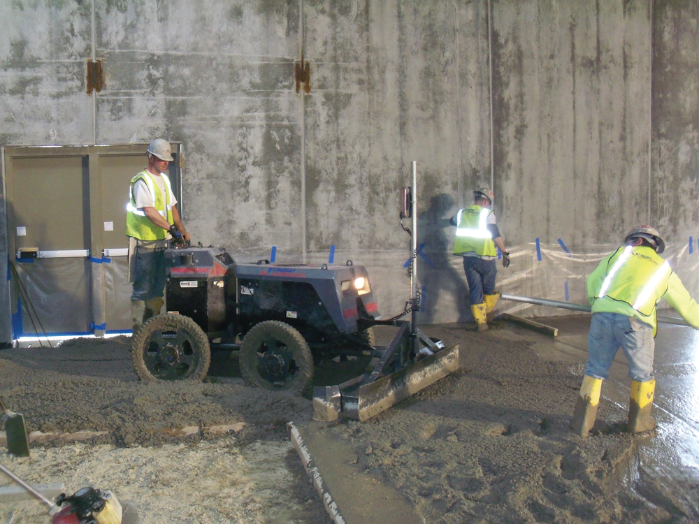 A Lindsay Lampasona crew uses a Somero Power Rake to verify subgrade tolerance before striking off a 20,000-square-foot floor at a Walmart in North Smithfield, R.I.