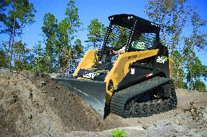 A compact track loader's tractive ability makes it well suited for use with ground-engaging attachments, such as dozer blades.