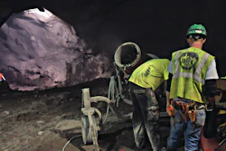 Workmen set up the DustBoss DB-60 on the blasting job for the 2nd Avenue Subway under Manhattan. Three of the machines, and one smaller unit, replace laborers with fire hoses, which would have cost the contractor up to $1 million per year on the job.