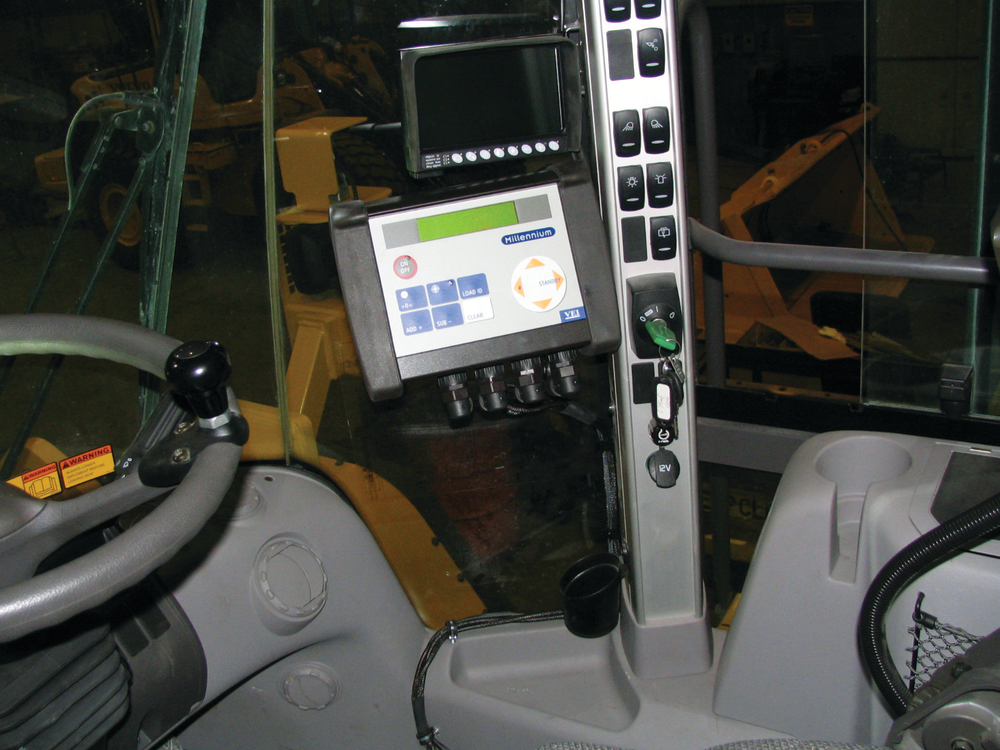 A Volvo L350 wheel loader is shown equipped with a VEI loader scale.