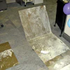 Water vapor that traveled through the concrete slab reached dew point and re-emulsified the water-based glue that once secured these carpet tiles to the concrete substrate.
