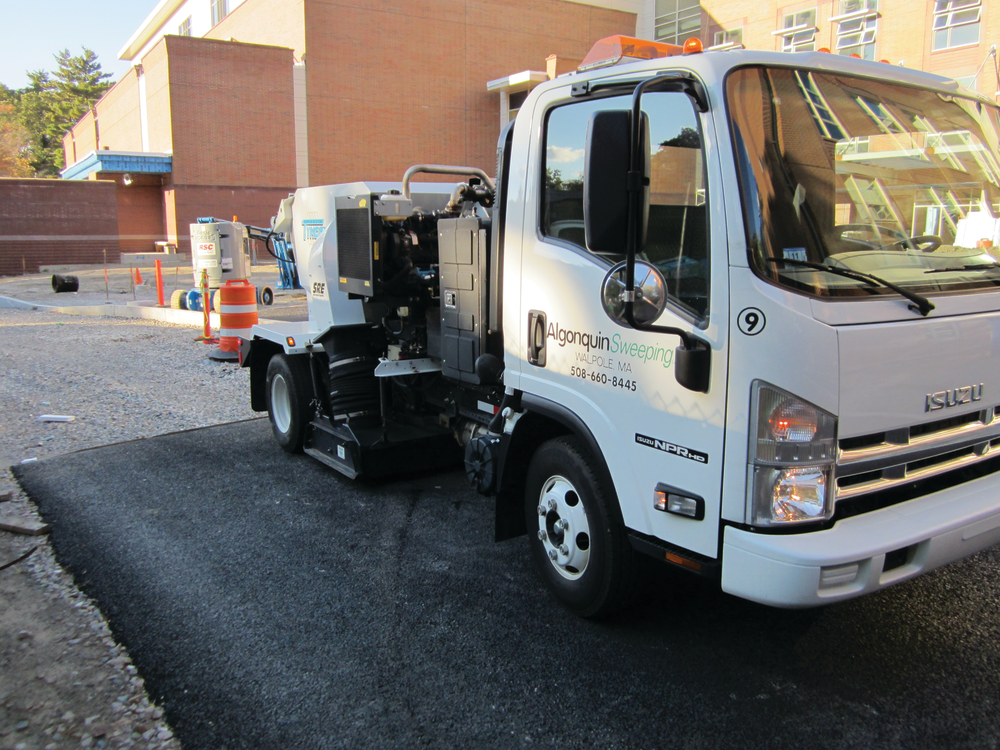 Algonquin Sweeping & Striping of Walpole,MA, completed construction site sweeping of porous pavement at Wellesley High School. Operators ran the Tymco 210 unit at a fairly low RPM increasing it to about 2200 RPM with each pass.