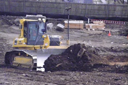 Komatsu dozer equipped with twin antenna Topcon 3D-MC2 automated grade control system levels out a steep slope.
