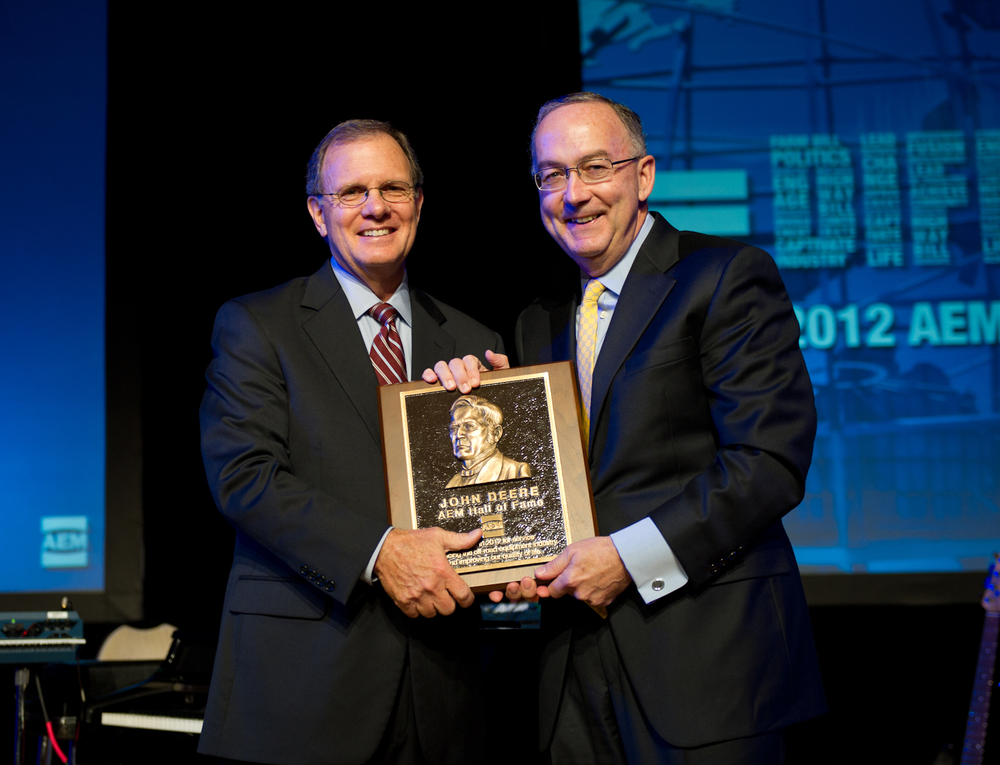 Sam Allen, Chairman and Chief Executive Officer, Deere & Company, accepts the AEM Hall of Fame plaque from Rusty Fowler, 2012 Chair of the AEM and CEO of Krone, North America