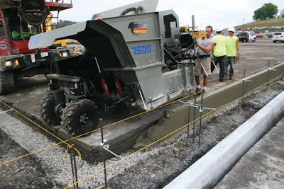 The mid-size curb and gutter machine pours close to the 90-degree transition point.