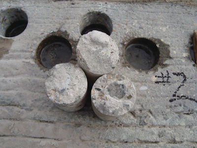 In-place concrete strengths represented by cores are typically less than lab-cured cylinder strengths due to field factors like consolidation and curing.