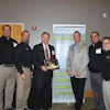 Alan Rose (holding plaque) accepts his Lifetime Achievement Entrepreneurial Excellence Award at a Sept. 11 ceremony. With Rose are some of his Rose Paving support (from left) Todd Dembinski, Larry Briar, Rose, Tim Chimack, Julio Chinea and Paul Price.