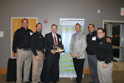 Alan Rose (holding plaque) accepts his Lifetime Achievement Entrepreneurial Excellence Award at a Sept. 11 ceremony. With Rose are some of his Rose Paving support (from left) Todd Dembinski, Larry Briar, Rose, Tim Chimack, Julio Chinea and Paul Price.