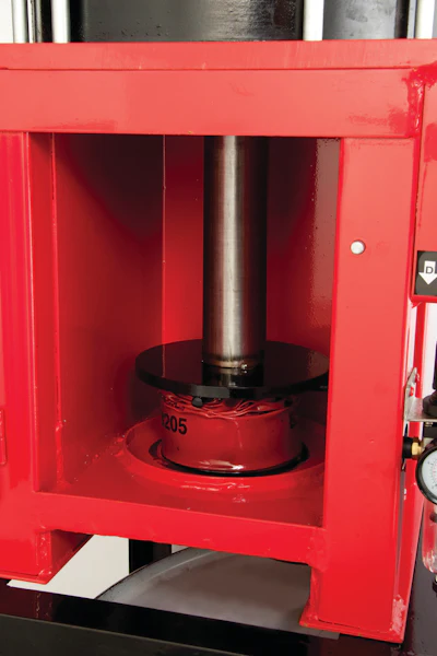 Oil filter crushers such as this one from Bendpak are designed to flatten oil filters and squeeze out all but the last traces of engine sludge and oil. Here, an oil filter can be crushed to 25% of its original size.