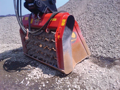 In some areas of the settling pond, previously excavated material is being mixed with a binding agent using two ALLU Screener Crushers.