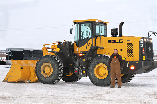 Cole Koch, superintendent and part-owner of Double K Excavating, in front of the company's new LG959, the first SDLG machine sold in North America.