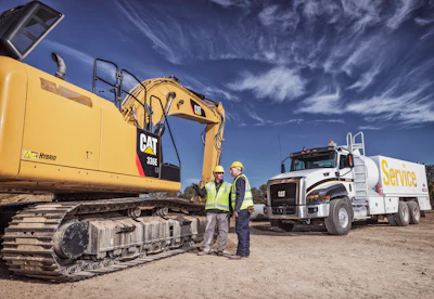 Cat Dealer Technician Consults With Equipment Manager