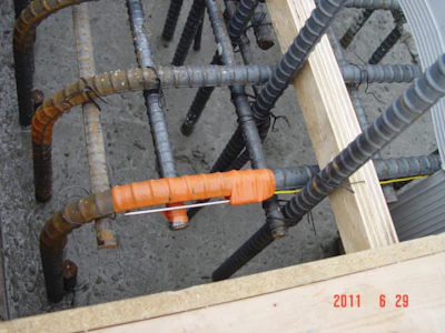 Place temperature sensors at center of the mass concrete and at a depth of two-inches from the center of nearest exterior surface. Take readings every hour and compare concrete temperature and temperature difference to specified maximum limits every 12 hours.