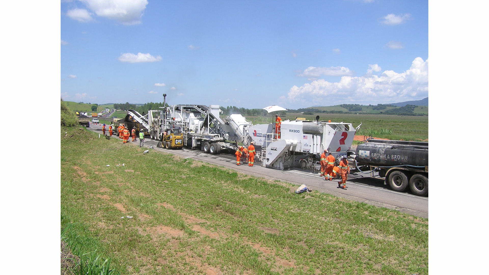 The roadwork train consisted of a water truck in front, emulsion tanker truck, Roadtec RX-900e cold planer, Roadtec RT-500 mobile recycle trailer, a Caterpillar paver, a Cat steel roller compactor and a Cat rubber tire compactor.