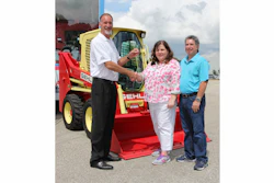 Dan Miller, CEO of Manitou Americas Inc. and President of the Compact Equipment Division hands over the keys to the Gehl R190 ‘Throwback’ sweepstakes winner Beth Hodges and her husband Robert from Indian Trail, N.C.