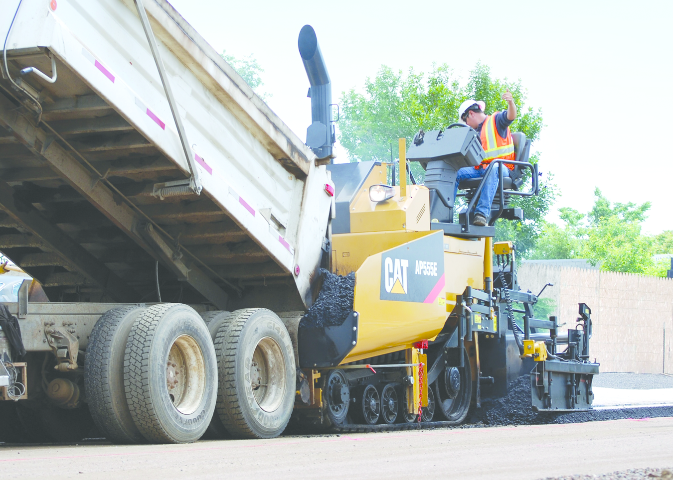 Schlouch Inc. replaced two of its asphalt pavers with new Caterpillar AP555E tracked models (such as the one shown) and featuring extended warranties. The replacements cut the company's paving costs significantly.