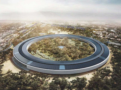 One thousand construction workers are at the site of Apple's Cupertino campus, and already 1.5 million tons of concrete has been poured for the new Apple donut complex. It's one mile in circumference and will be four stories tall with a complete solar layer atop when finished.