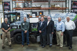 In front of the NiteHawk's camouflage sweeper (which raised $1500 for DAV) are (from left) Tracy Day, President, NiteHawk Sweepers; Bob Anderson, President, Davidson-Macri Sweeping; Robert Lougee, DAV; Bill Centers, U.S. Navy Rear Admiral, retired; Ron Robinson, CEO and President, Alamo Group; Jeff Leonard, Vice President, Alamo Group. The new NiteHawk facility is located at 19713 58th Place S., Kent, WA.
