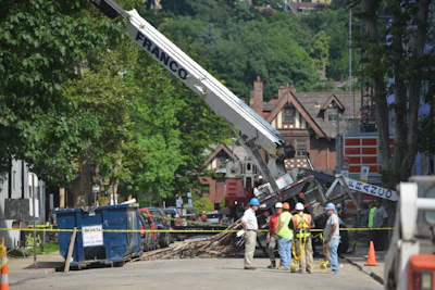 Worker error may be to blame after a crane tips over while lifting scaffolding.