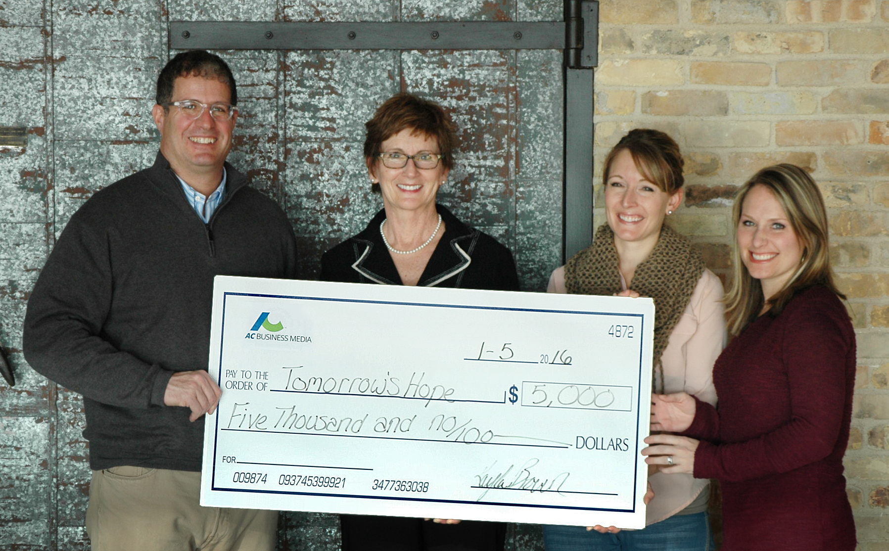From left to right: Carl Wistreich, President and CEO of AC Business Media; Barb Endl, Executive Director, Tomorrow's Hope; Kayla Brown and April Van Etten, representing the AC Business Media employees