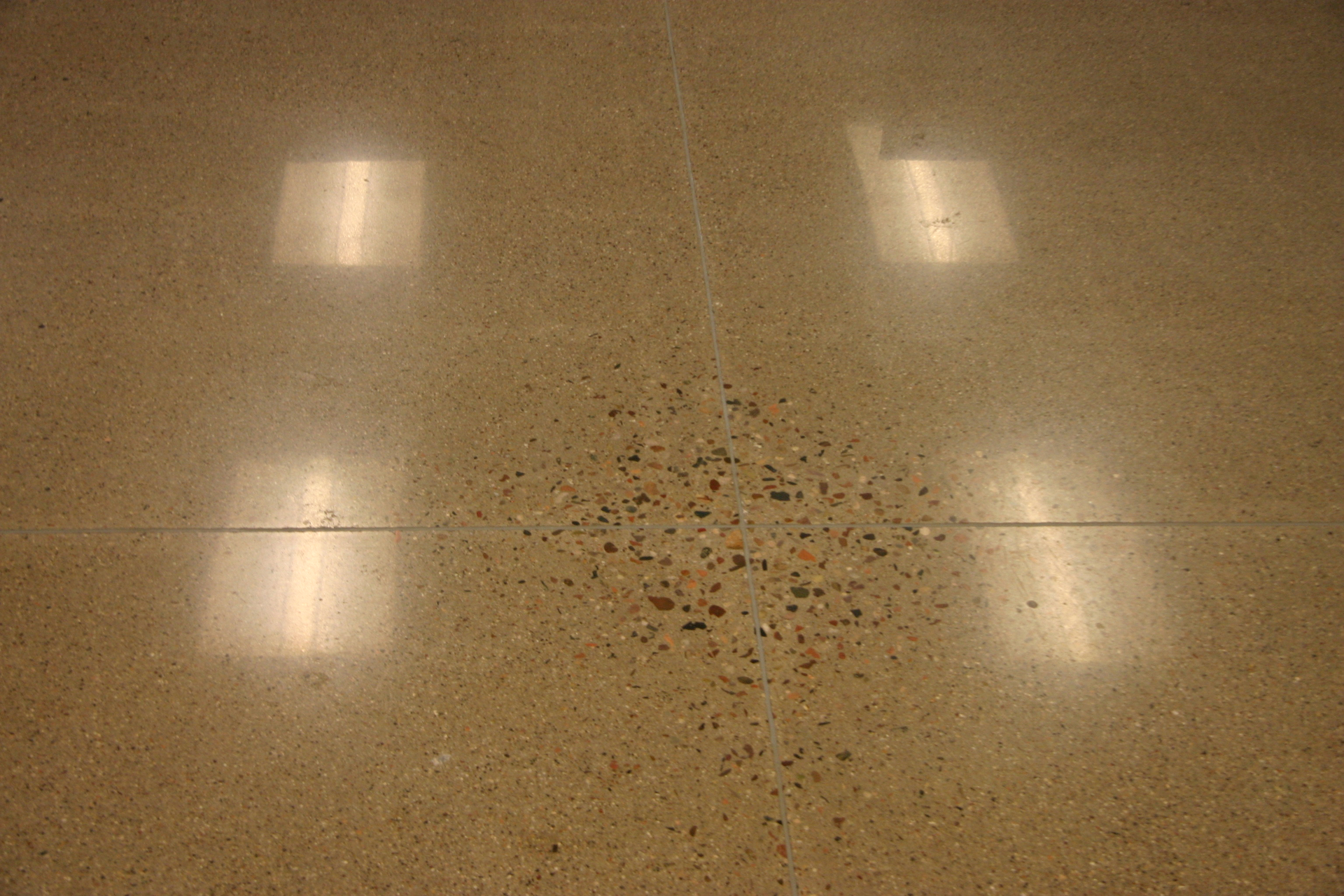 When slabs on ground are polished, non-uniform exposure of aggregate is a result of high spots cause by slab curling. Deflection of many suspended slabs exceeds the upward movement at curled slabs, so polishing may result in even larger areas that exhibit such non-uniform aggregate exposure.
