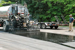 Asphalt emulsion bond coat placed full width with overlapping nozzle pattern will result in more durable parking area overlay.
