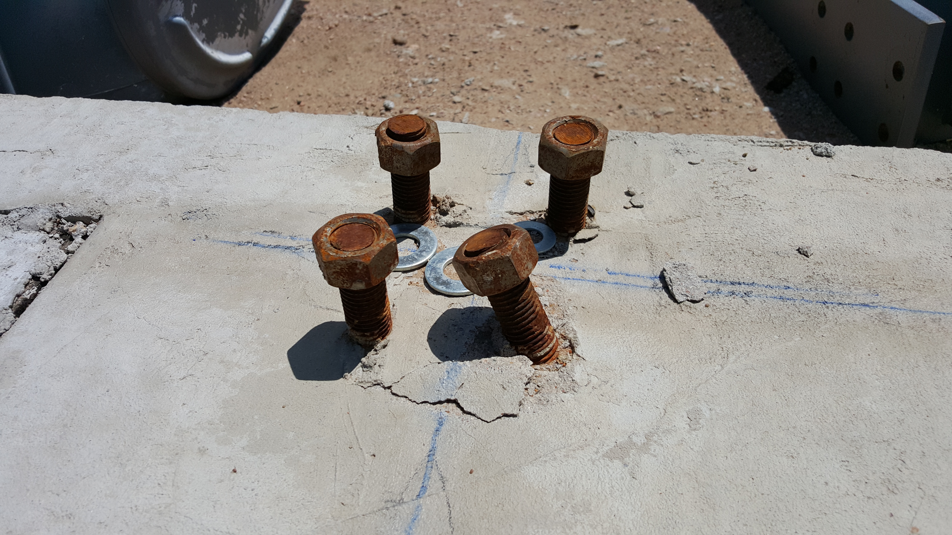 Photo 3 - For misaligned or bent anchor bolts that will not allow the base plate to fit over the bolts, consider bending the bolts into position.