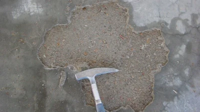 Surface delaminations are separations of the top surface from the underlying concrete.