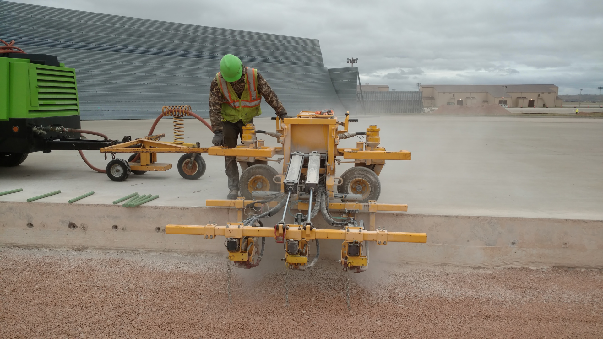 A Structural Associates crew member watches closely while operating an E-Z Drill 210-3 SRA slab rider at Westover Air Reserve Base. In all, the contractor drilled 27,000 holes as part of a project to update the base’s aircraft refueling system.
