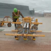 A Structural Associates crew member watches closely while operating an E-Z Drill 210-3 SRA slab rider at Westover Air Reserve Base. In all, the contractor drilled 27,000 holes as part of a project to update the base’s aircraft refueling system.