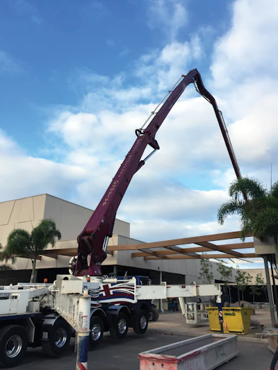 An assortment of specialty concrete placing tasks required the long reach of the 61-meter to extend over mall buildings to reach areas on the other side.