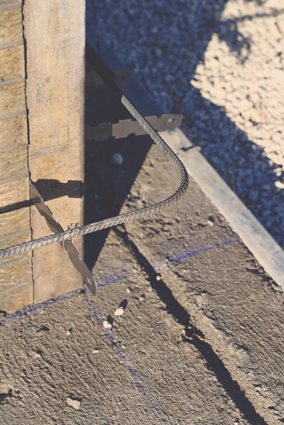 Chalk lines on the footing designate the inner formwork wall line. The width of the footing minus the wall thickness should leave enough footing along the outside to support the wall forms.