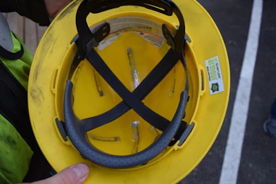Cat Detect uses RFID technology to notify operators when any jobsite personnel is within a specified distance of a machine. The RFID device is worn in a vest or hardhat (see right of brim) of a worker who is on the ground.