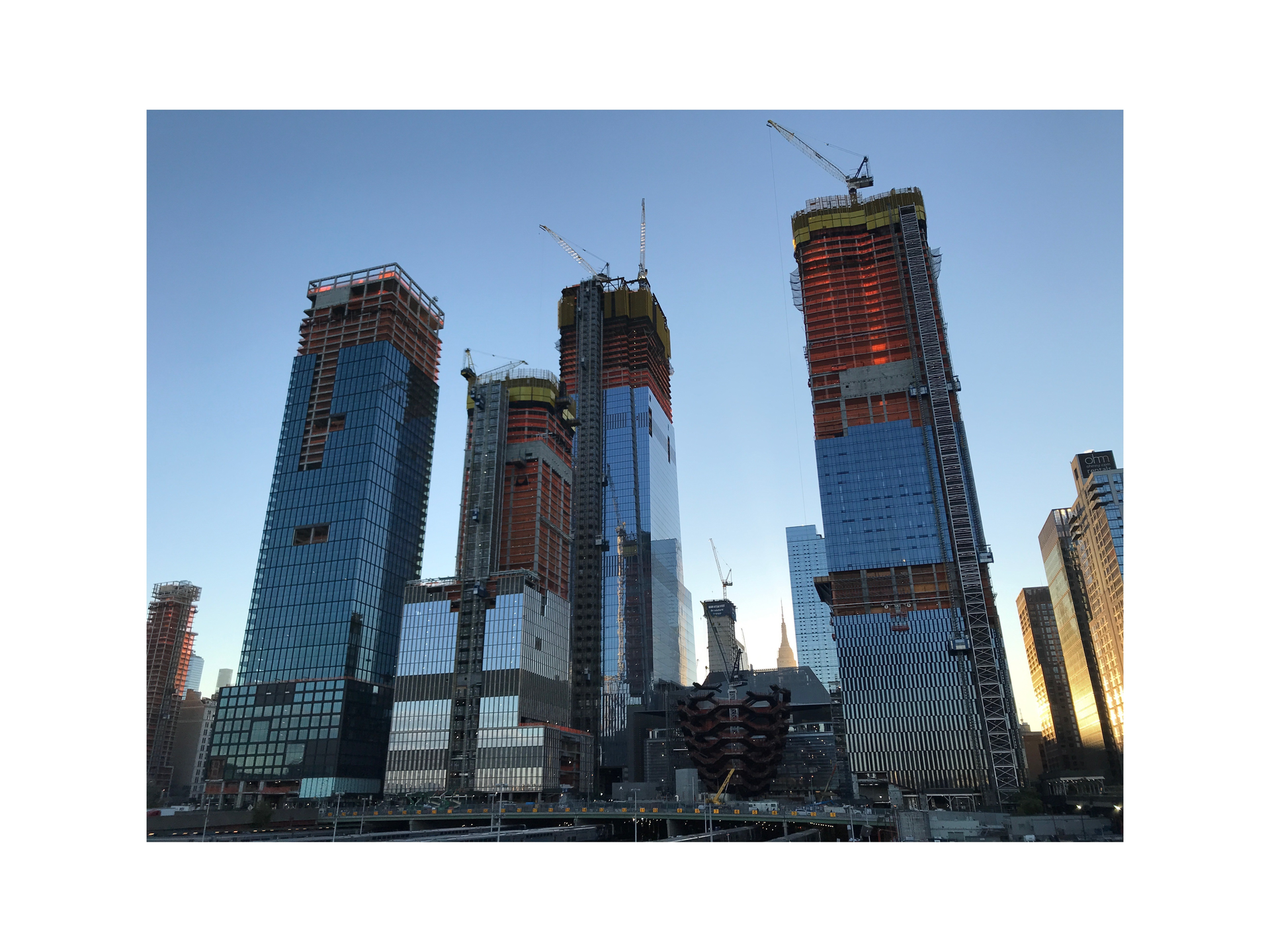 The Hudson Yards project includes office towers, 4,000 residences, a 750-seat public school, shops and restaurants, a new art center and 14 acres of public open space. It is constructed on two “platforms” that bridge over 30 active Long Island Rail Road train tracks; 300 caissons (4 to 5 ft. in diameter, 20 to 80 ft. deep) support the platforms and buildings.