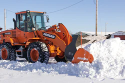 Make sure snow pusher attachments interfacing with a bucket are properly secured prior to use.