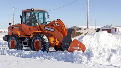 Make sure snow pusher attachments interfacing with a bucket are properly secured prior to use.