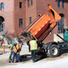 The Public Works Department team using its Falcon hot box and recycler to make repairs outside New Trier High School in Winnetka, IL. Built to be slid into the bed of a truck, the Falcon unit is available in 2-, 3-, 4-, 5-, 6-, 8- or 10-ton capacities.