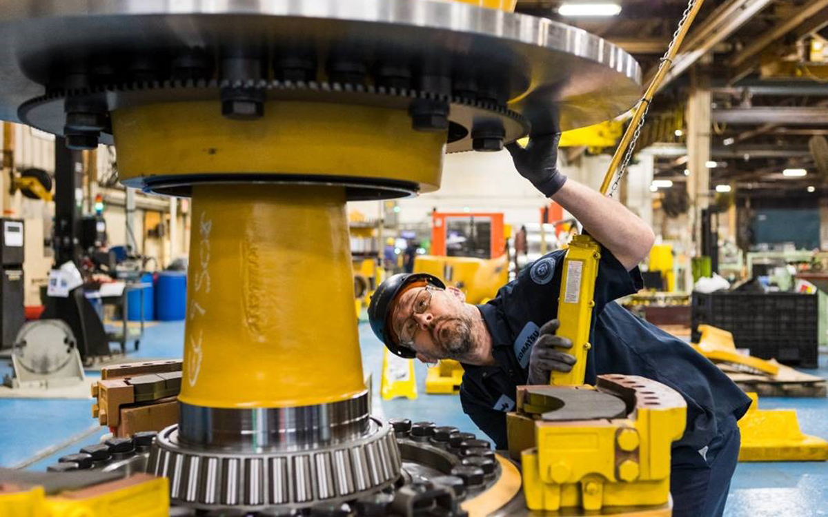 Komatsu employee at the Peoria, Ill., plant inspects an electric dump truck component. Komatsu has 28 U.S. manufacturing facilities that produce construction, mining, forklift and forestry equipment.