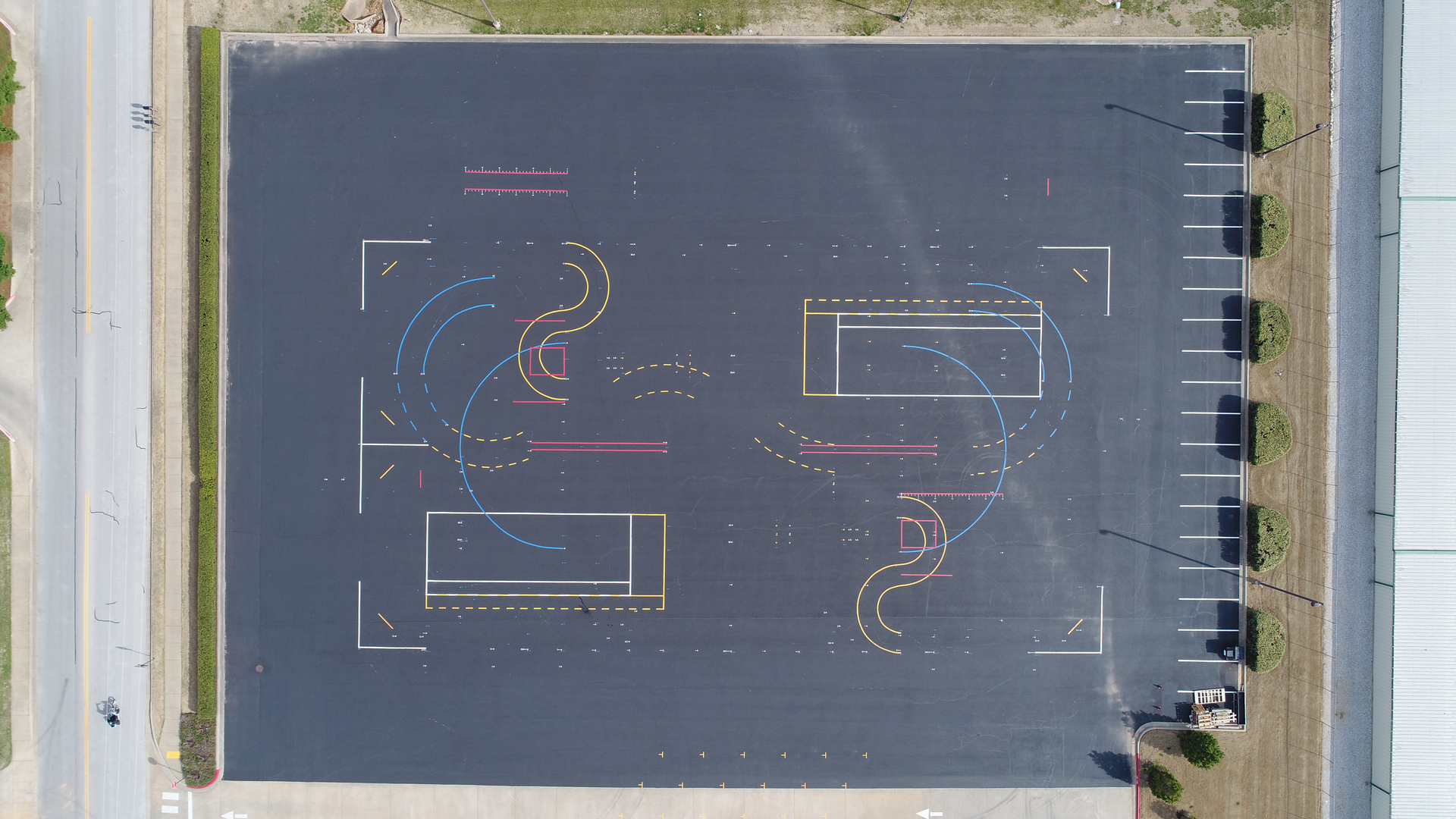 Layout of the training area started with marking the four corners of the 30,000-sq.-ft. area, creating the outlines of a rectangle. Bolts were screwed into the pavement at the four spots, and the four points were connected by a nylon baling cable, creating the outlines of a rectangle. This long sides of the rectangle served as reference points to help position markings within the test track.