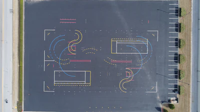Layout of the training area started with marking the four corners of the 30,000-sq.-ft. area, creating the outlines of a rectangle. Bolts were screwed into the pavement at the four spots, and the four points were connected by a nylon baling cable, creating the outlines of a rectangle. This long sides of the rectangle served as reference points to help position markings within the test track.