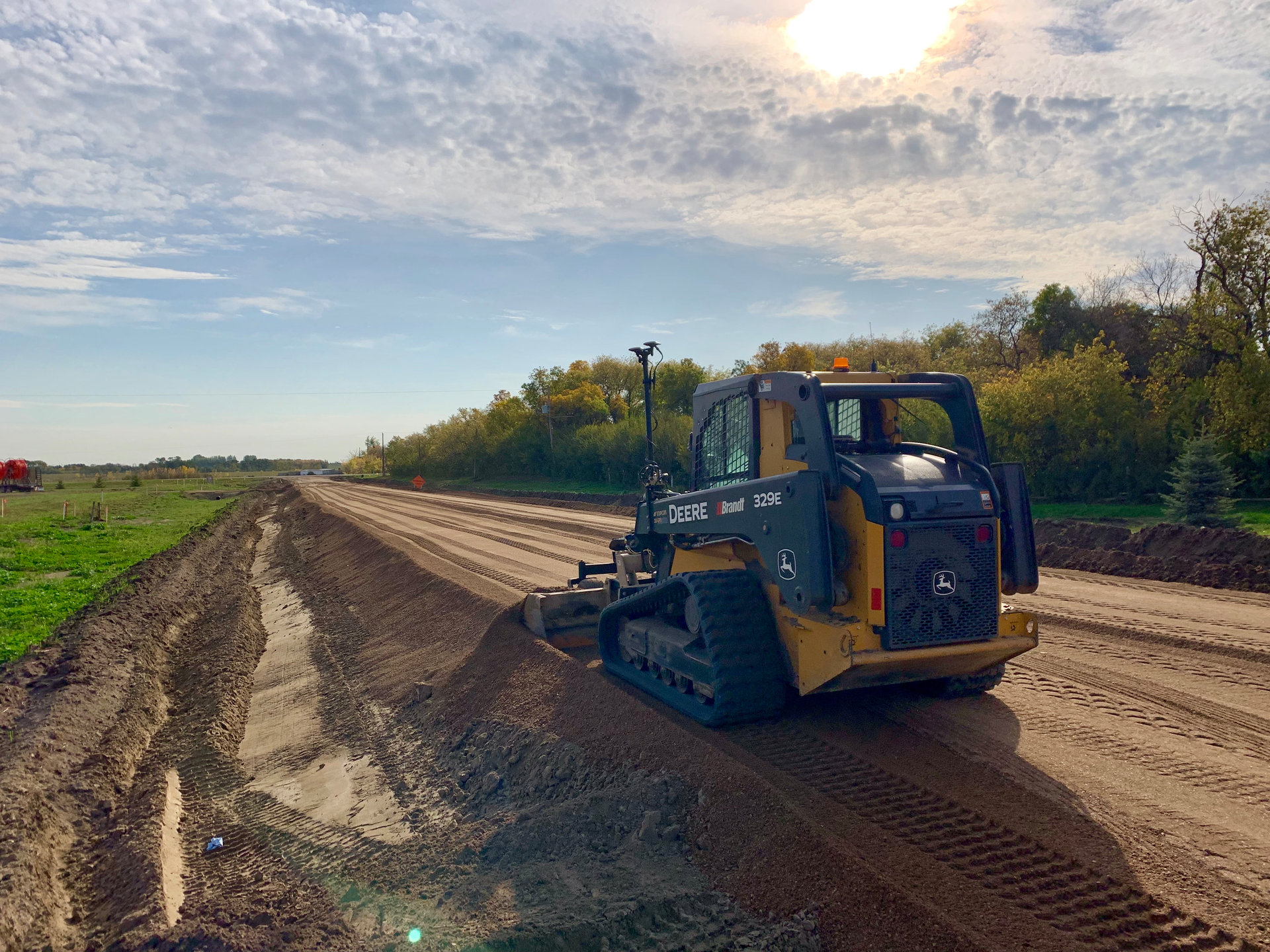 For the project, Warman Excavating used its Komatsu D-65EX crawler dozer and a John Deere 329 compact track loader (SSL), both equipped with Topcon 3D-MC2 machine control, acquired from Brandt Tractor.
