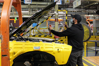 An operator at FCA’s Brampton Ontario Assembly Plant installs a removable plexiglas partition in the engine compartment of a Dodge Challenger to maintain proper distancing between the employees working in the area. The barrier is installed to protect employees from the spread and transmission of COVID-19. With protecting the health and safety of its employees a top priority, the Company is implementing robust protocols that will ensure all facilities are safe, secure and disinfected when production resumes.