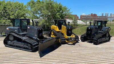 The first two commemorative units were D6 XE electric drive dozers, featuring a sleek dark gray and black paint scheme. The third commemorative unit is a D6 dozer finished in traditional Cat yellow with special black tracks and blade.
